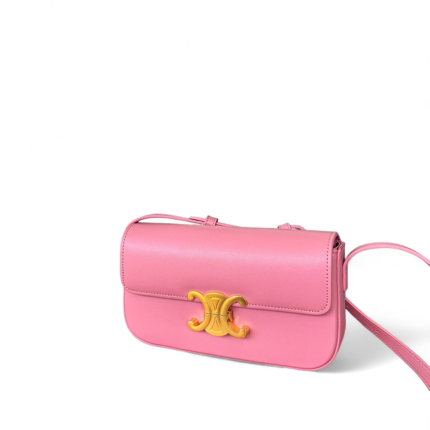 A pink leather crossbody bag with a gold-tone emblem and a sleek strap, presented against a white background.