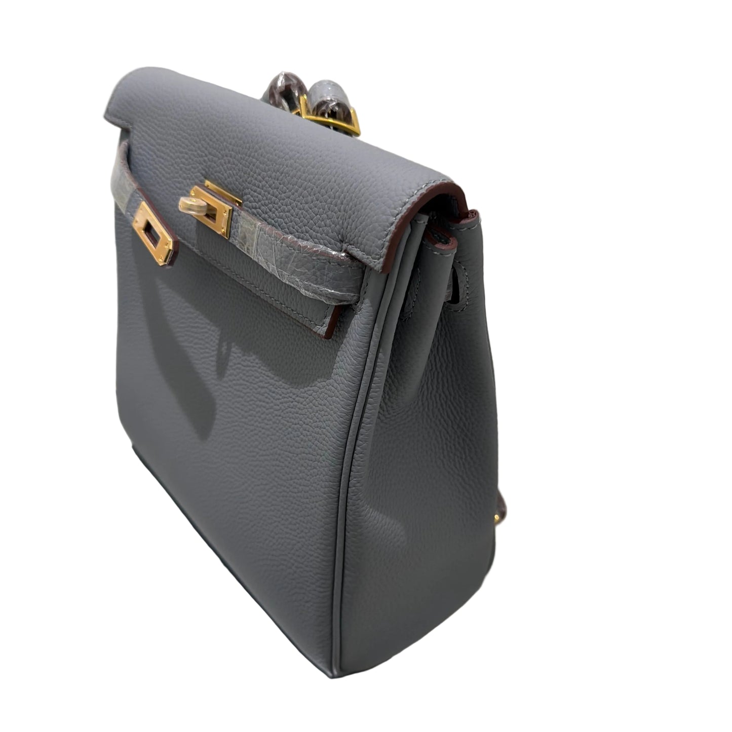 Gray leather bag with gold accents on a white background