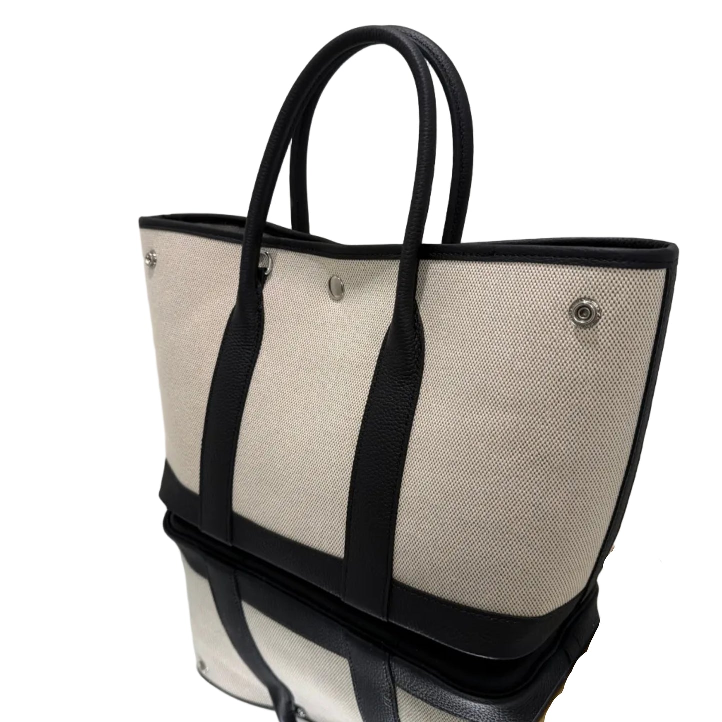 Beige tote bag with black straps on a white background