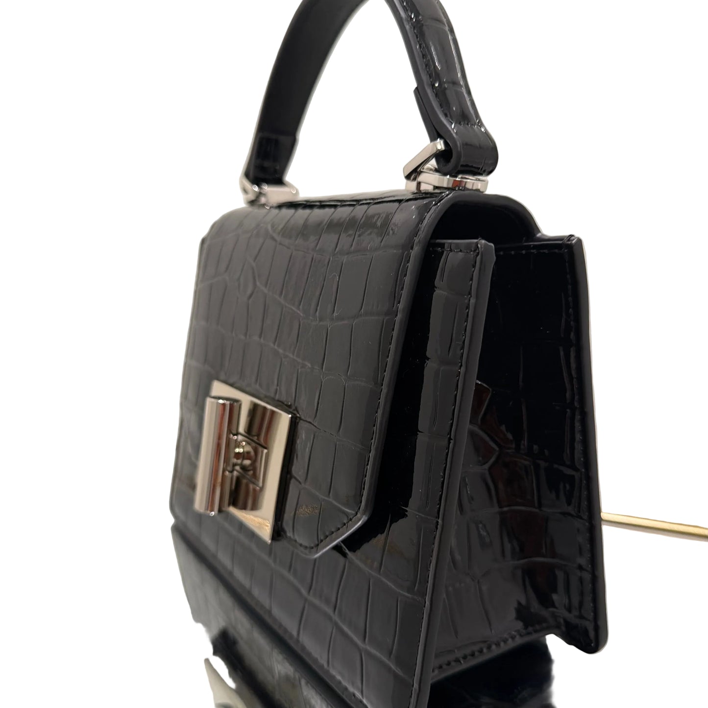 Black crocodile-patterned handbag on a light background