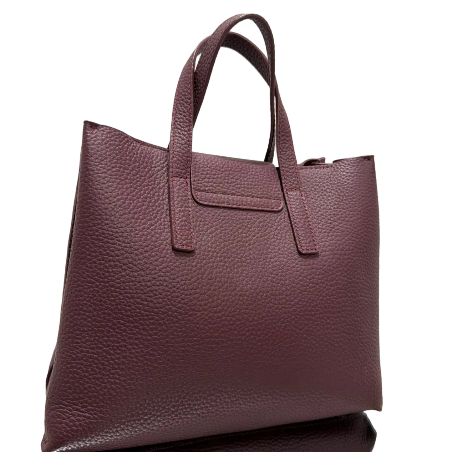 Brown leather handbag with a visible brand logo on a light background