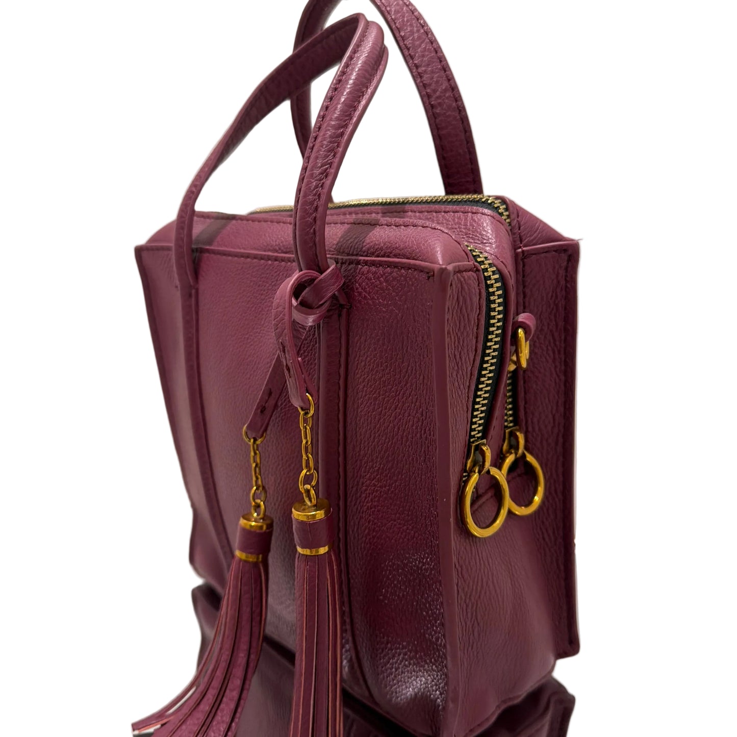 Purple handbag with gold zippers on a white surface
