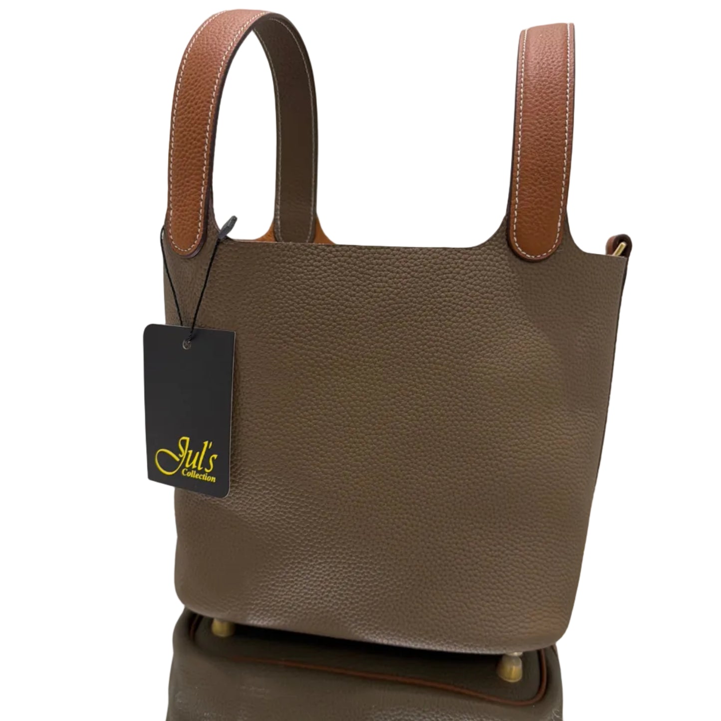 Brown leather handbag with a visible brand tag on a light background