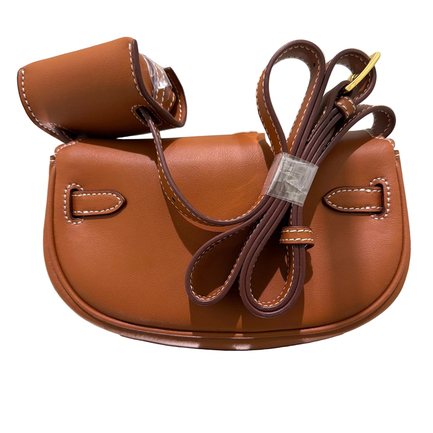 Brown leather sandal with a bow on a reflective surface