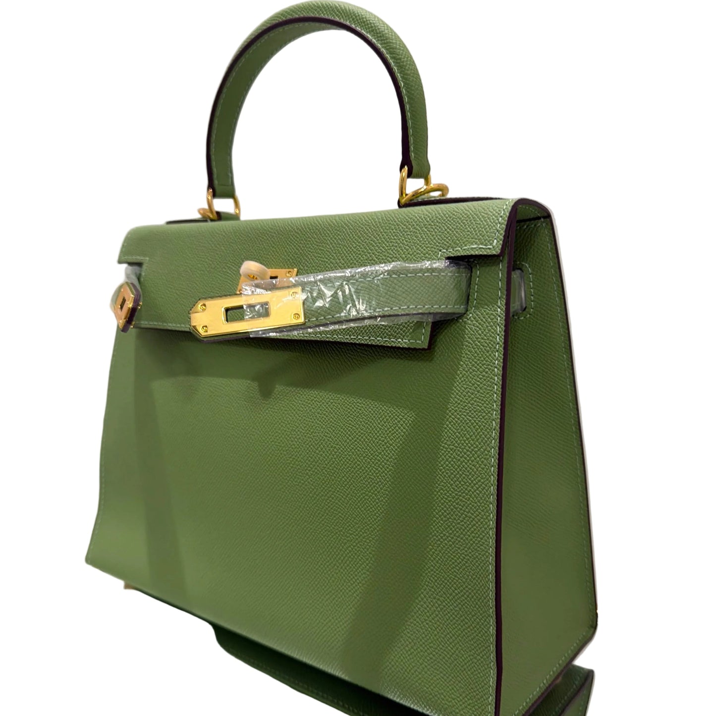 Green handbag with gold accents on a white background