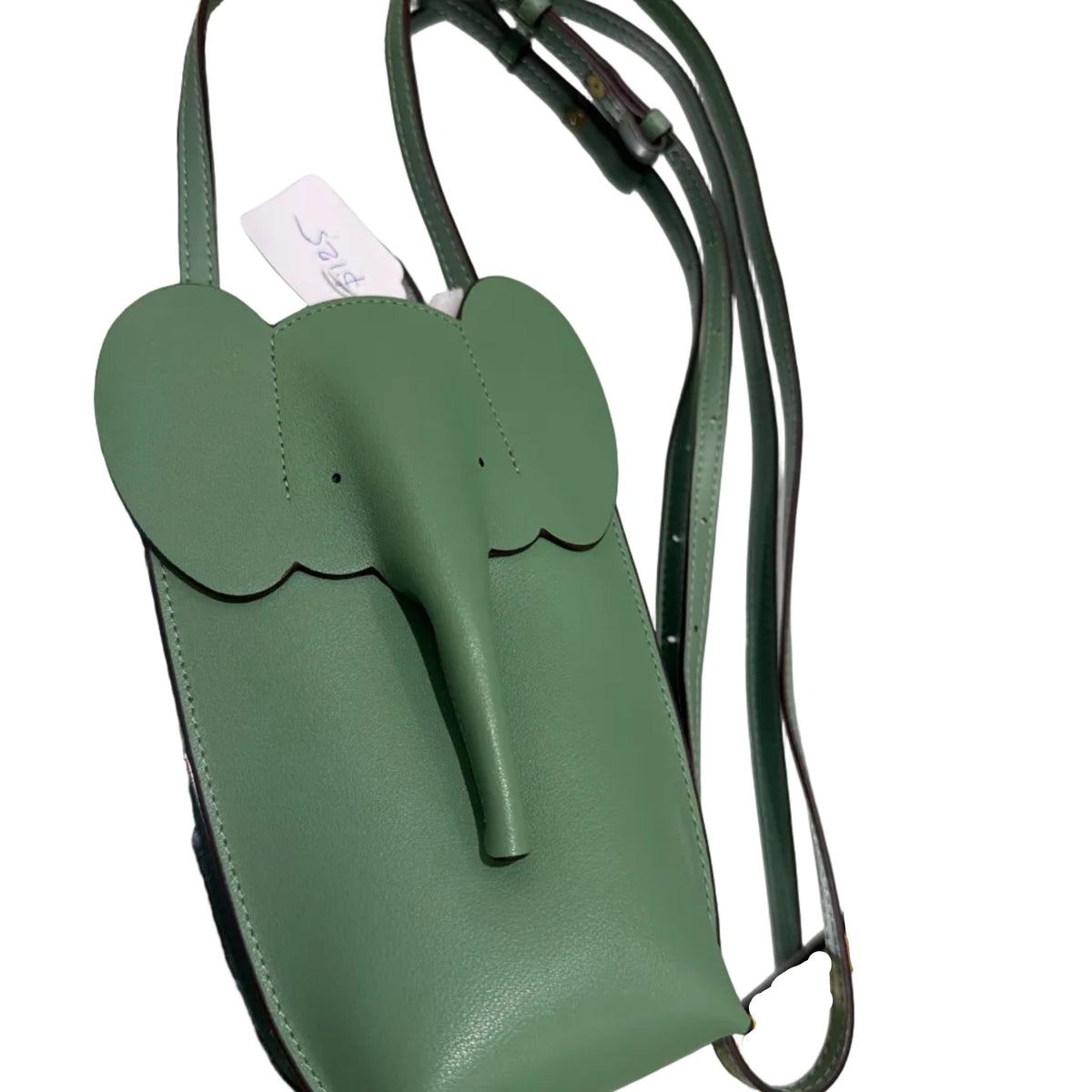 Green handbag with a unique design on a reflective surface
