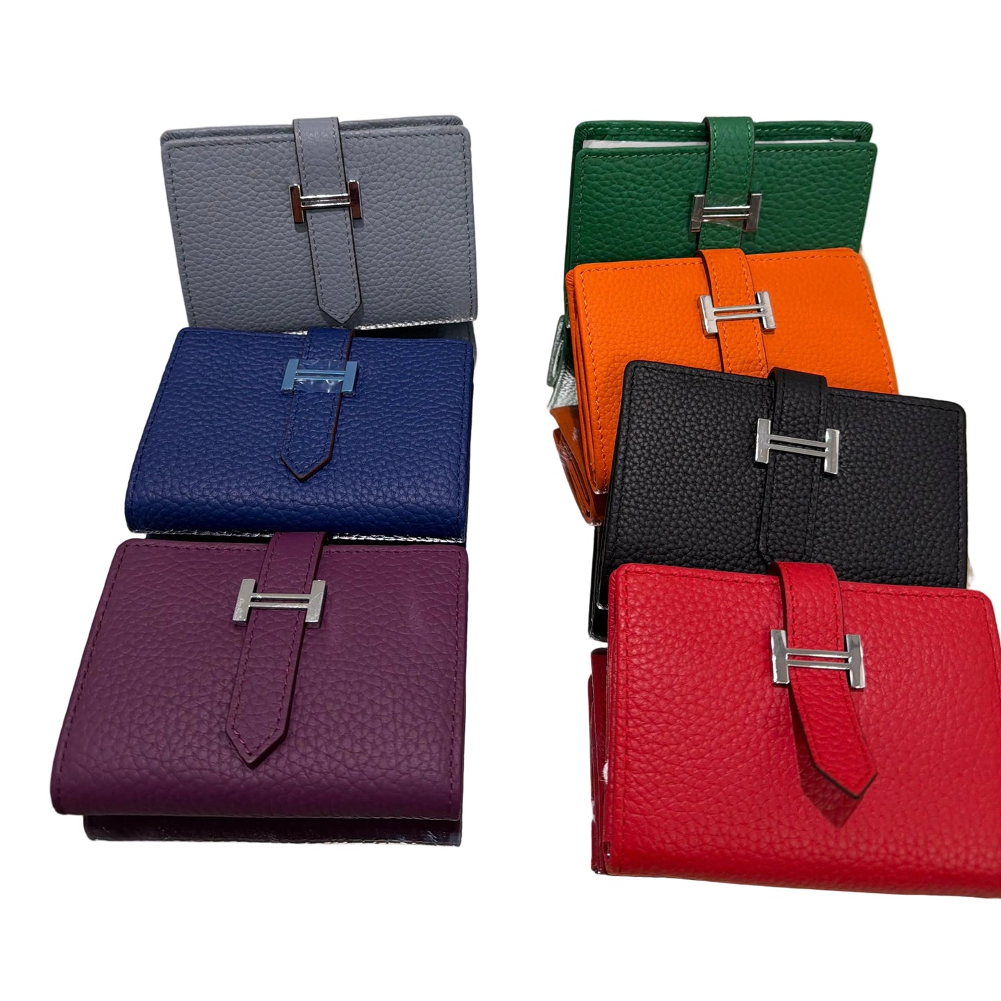 Set of colorful leather wallets displayed on a stand.
