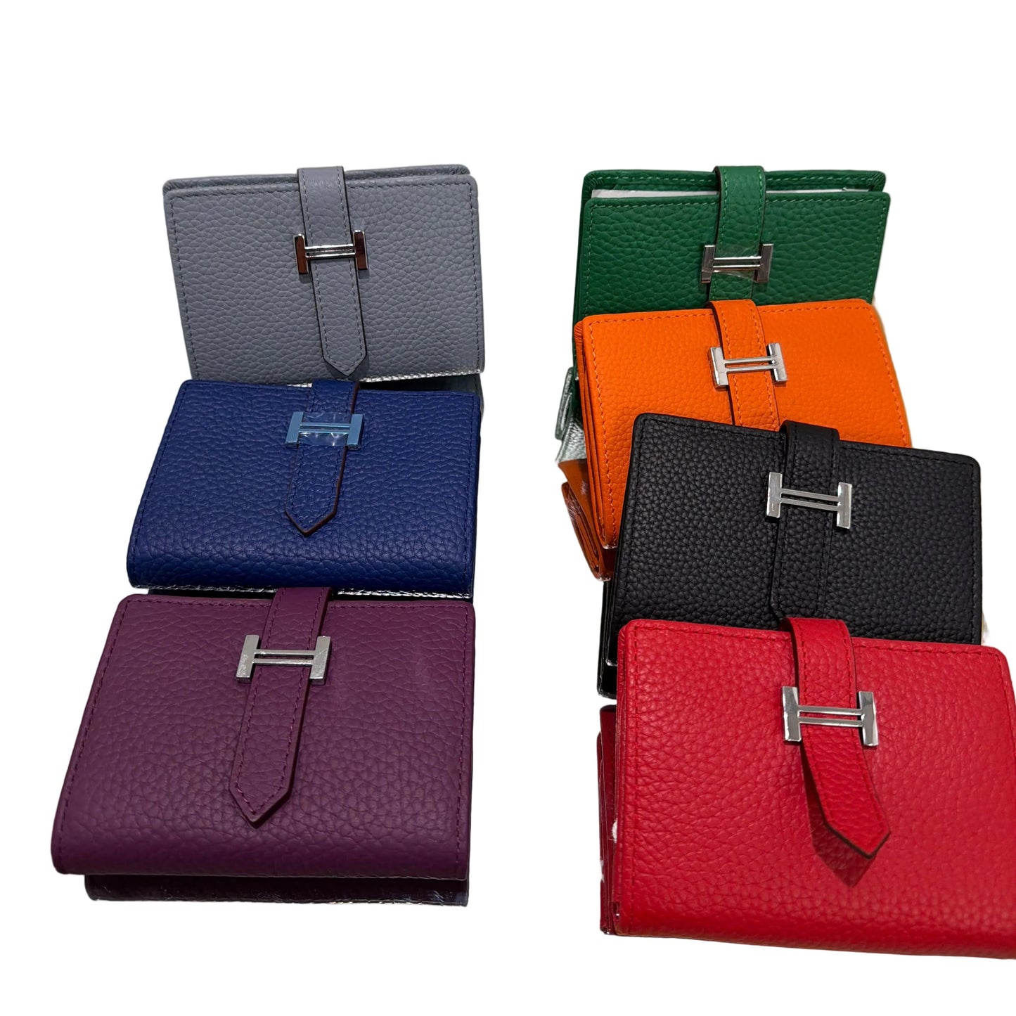 Set of colorful leather wallets displayed on a stand.