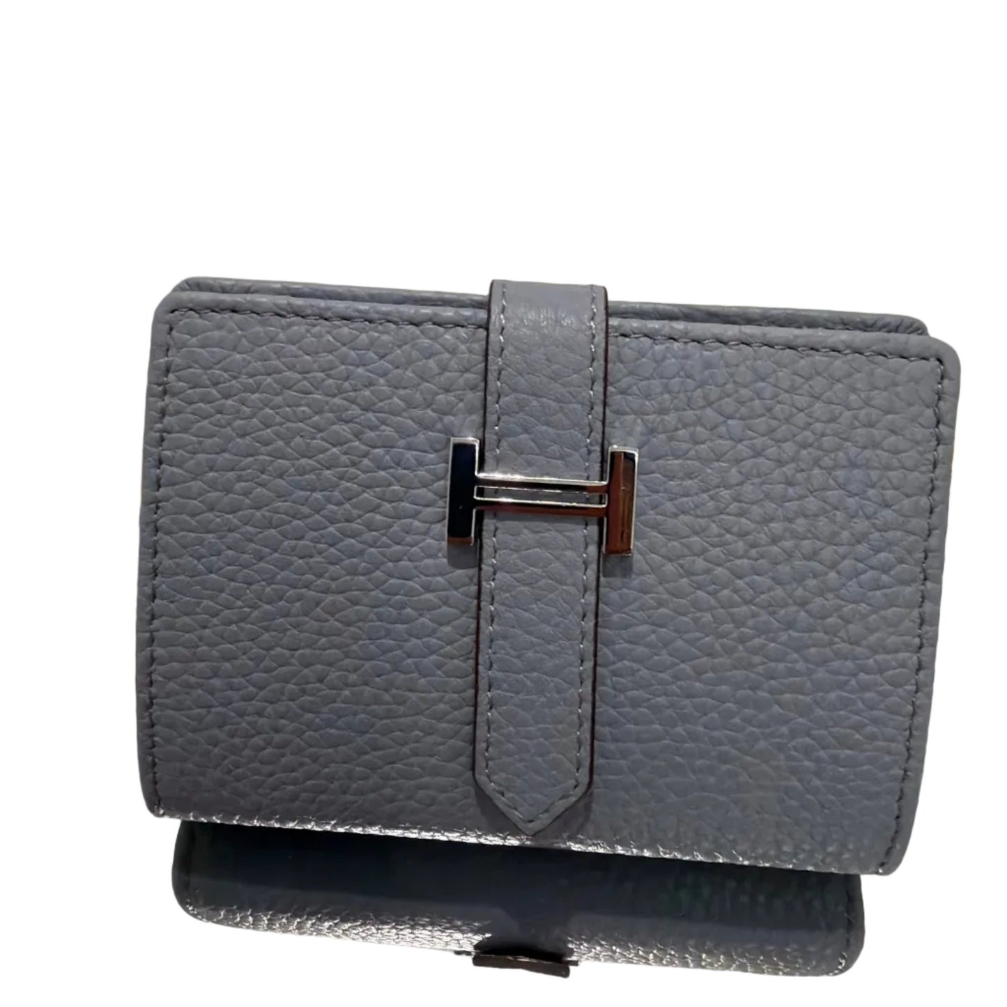 Gray textured wallet with a silver buckle on a light gray background