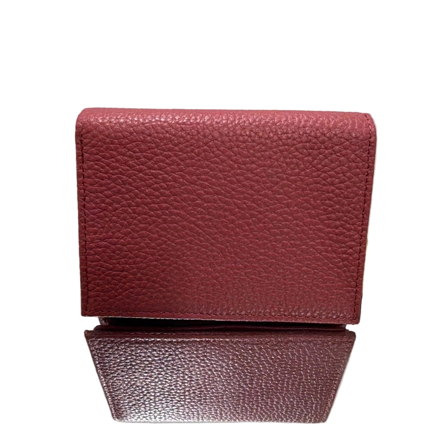 Red textured wallet on a stand against a white background