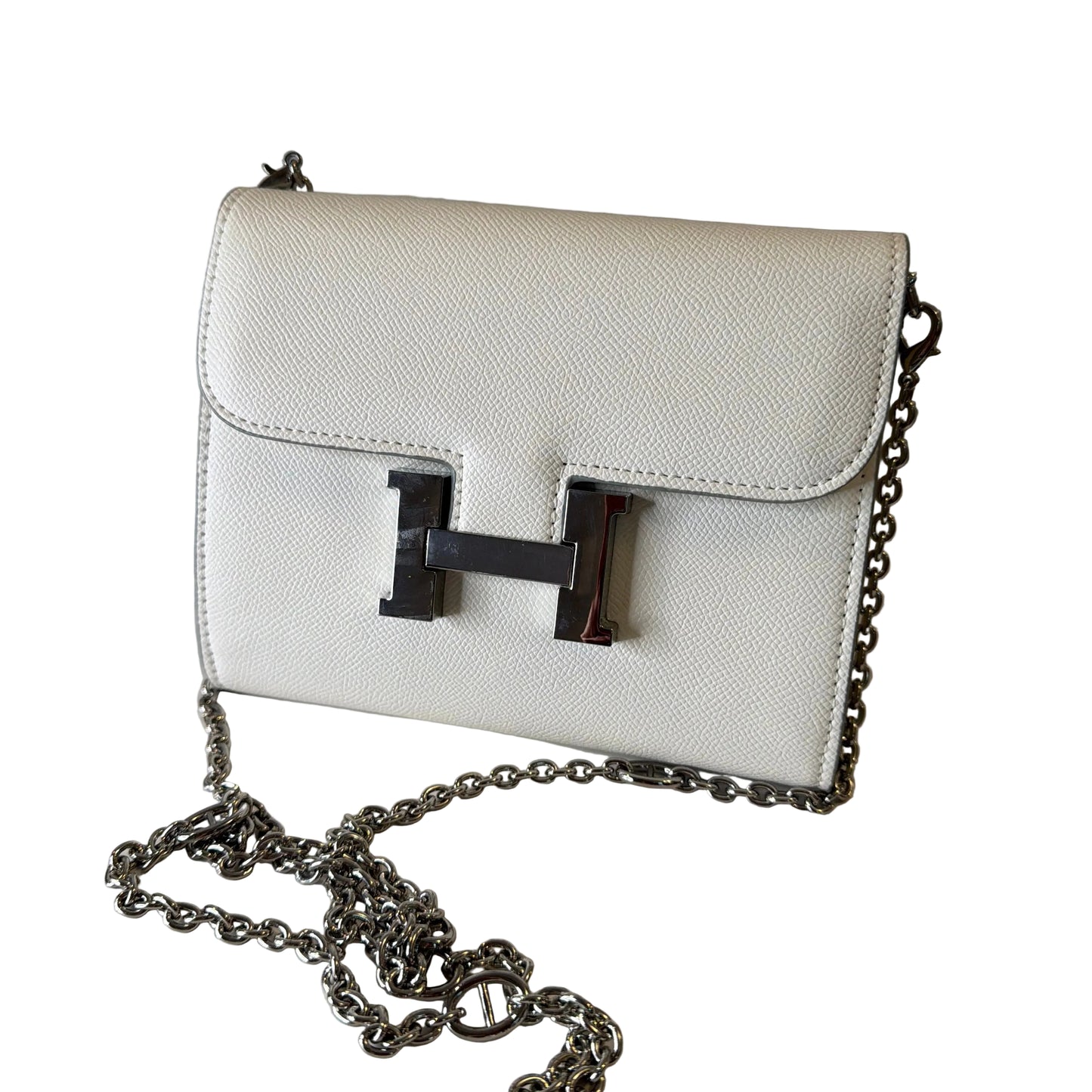 White handbag with a chain strap on a light gray background