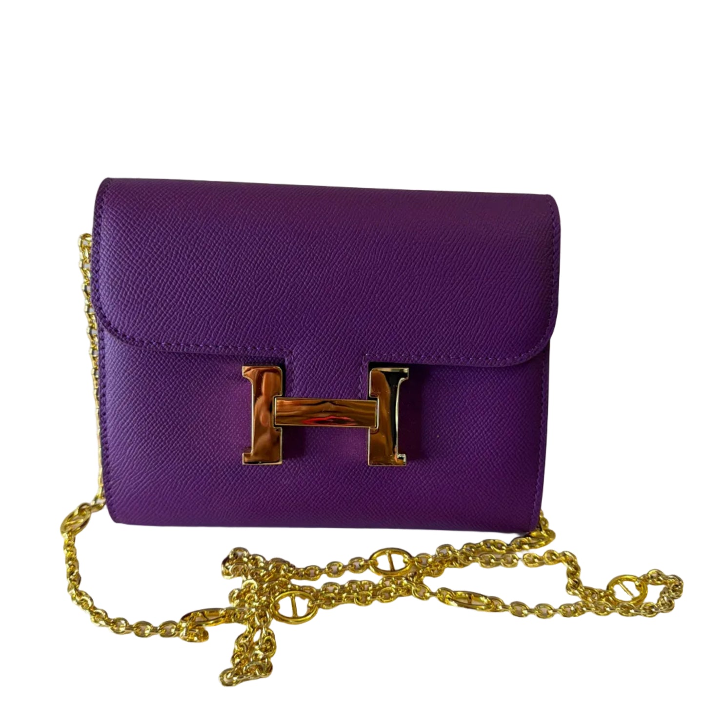 Purple handbag with gold chain on a white background