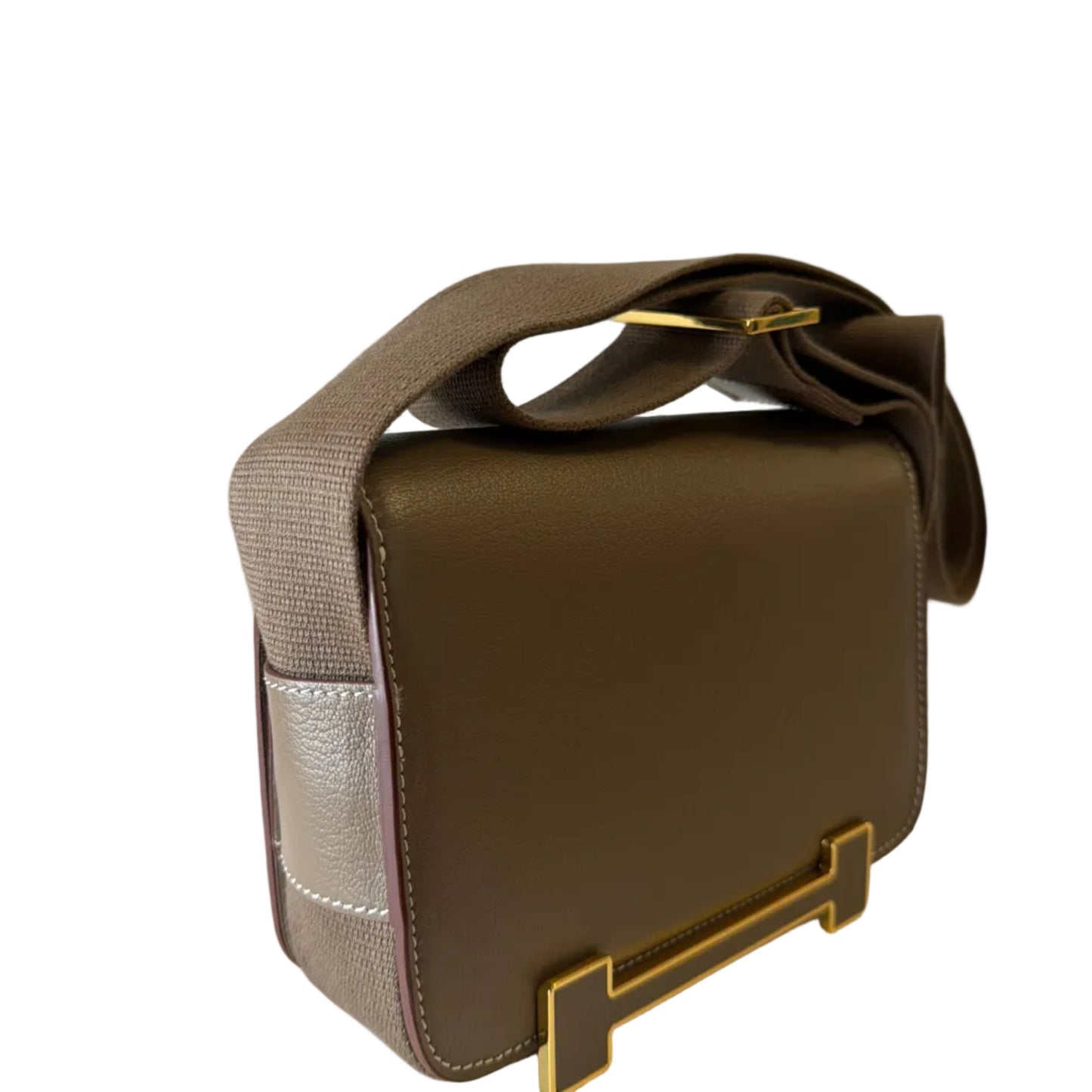 Brown leather bag with gold accents on a light gray background