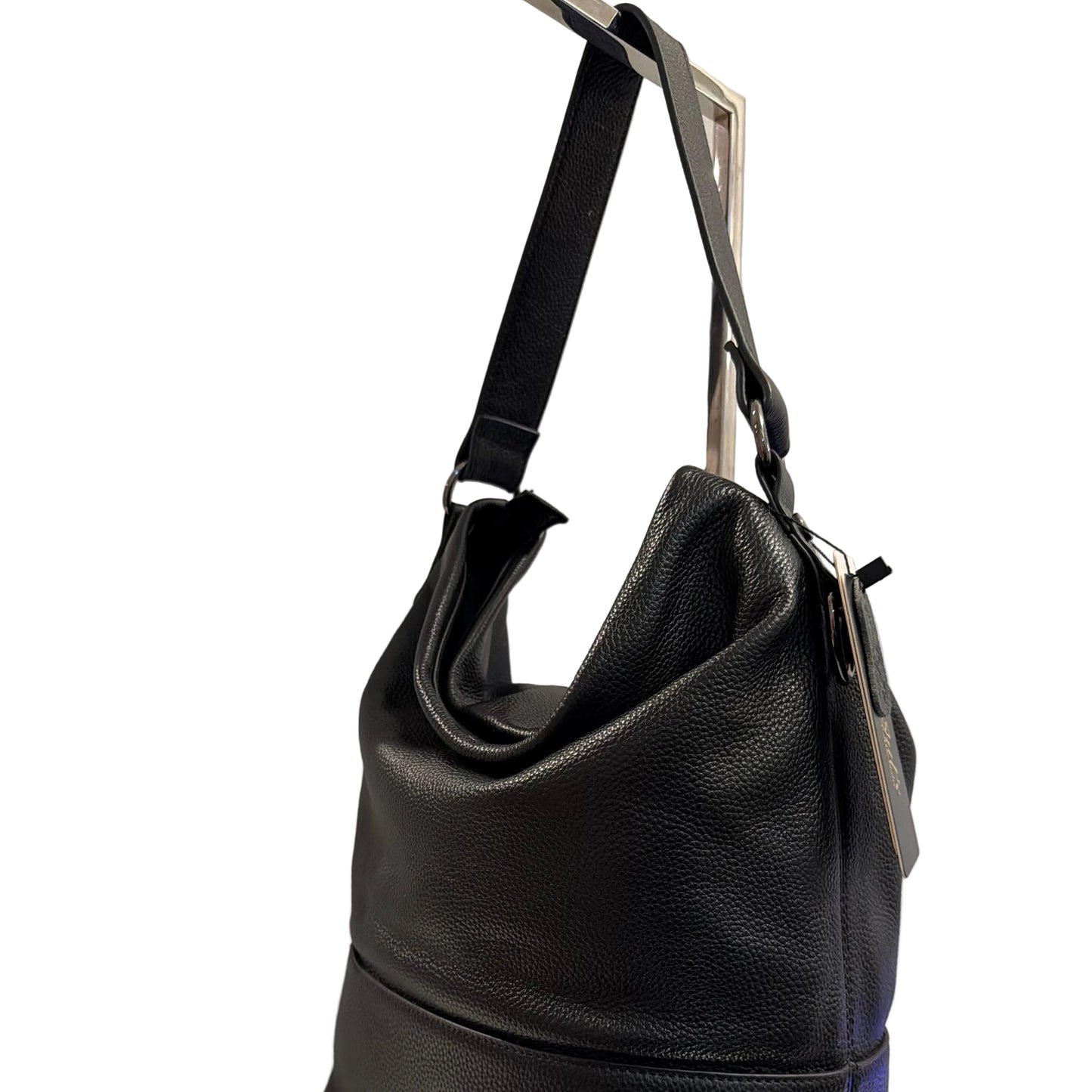 Black leather handbag on a white surface