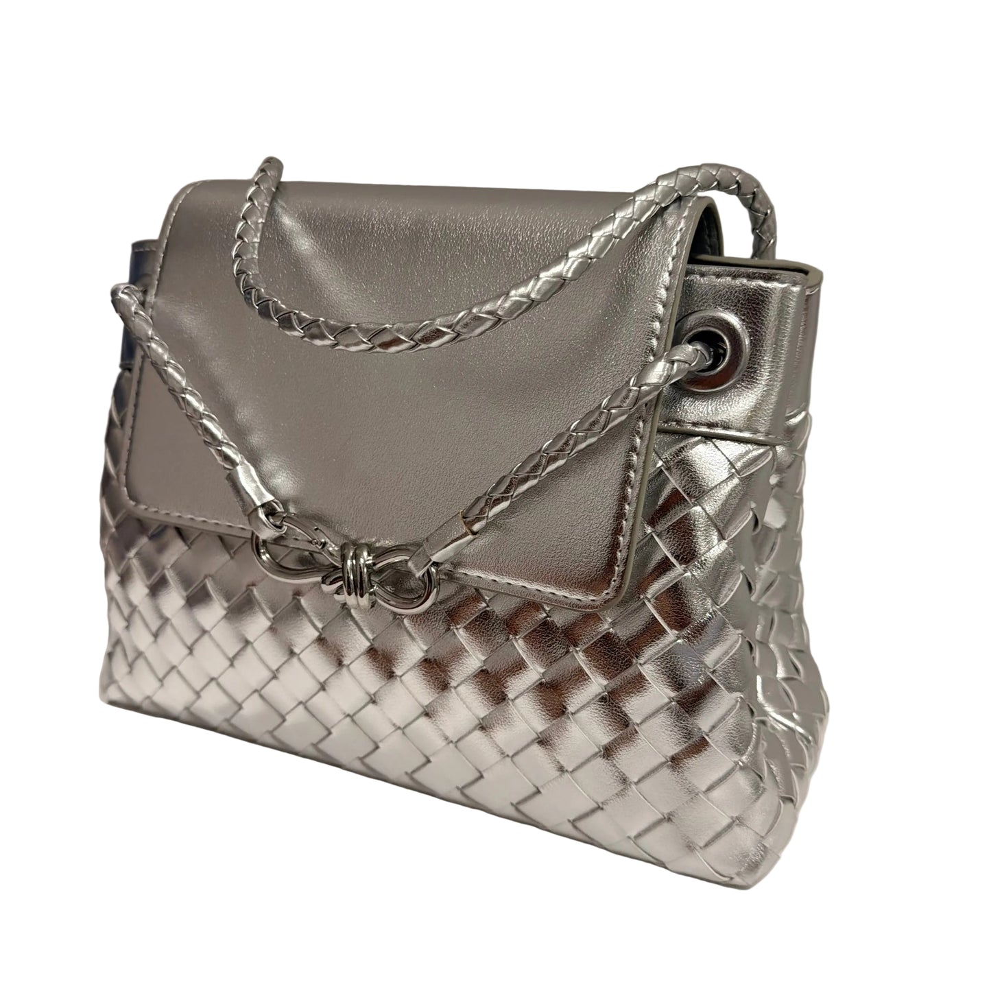 Silver woven handbag on a white surface with a neutral background