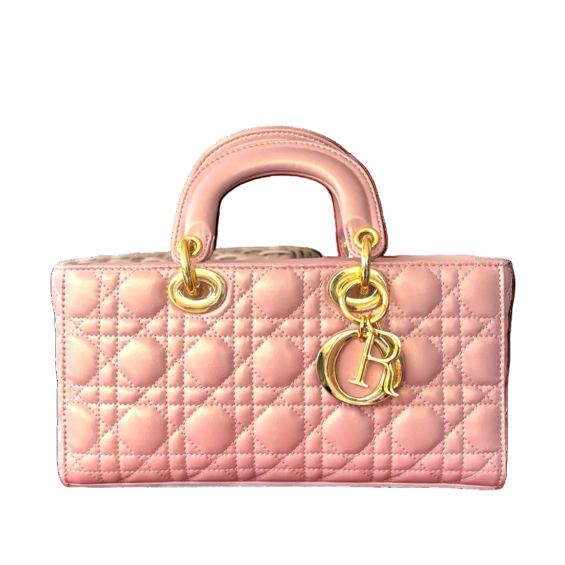 A soft blush pink leather handbag with a quilted pattern and a gold-toned hardware closure.
