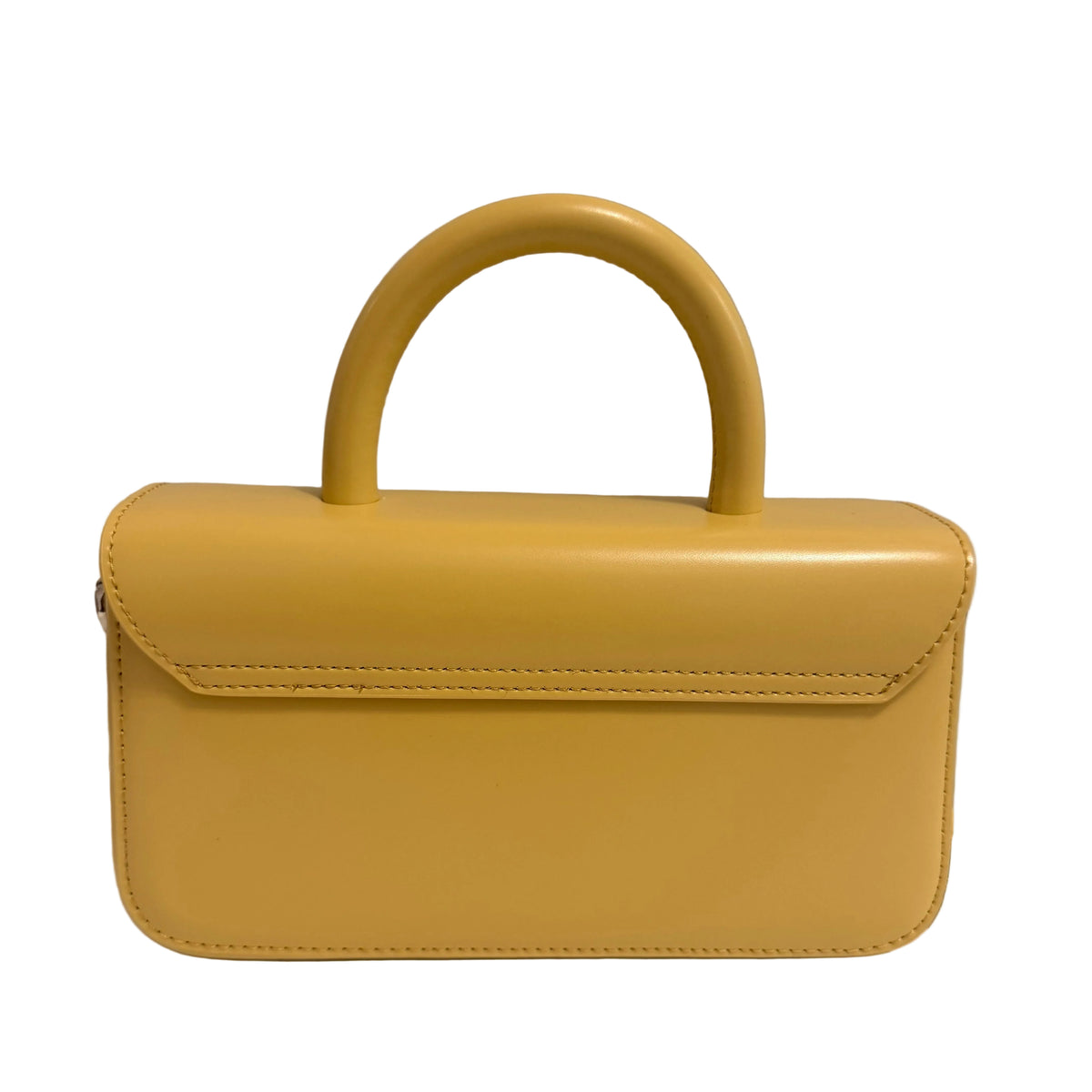 A mustard yellow patent leather handbag with a rounded top handle, shown from a side profile against a plain off-white wall.