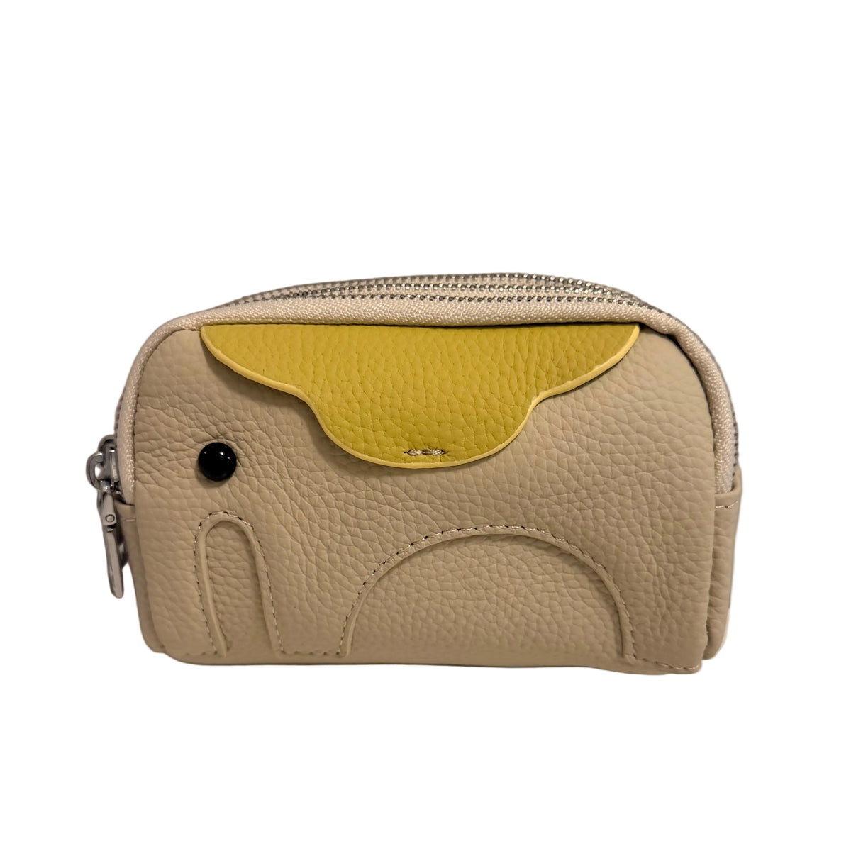 A small pebbled leather zip pouch in light beige with a contrasting yellow curved accent panel on the front, photographed against a plain light gray wall and white surface.