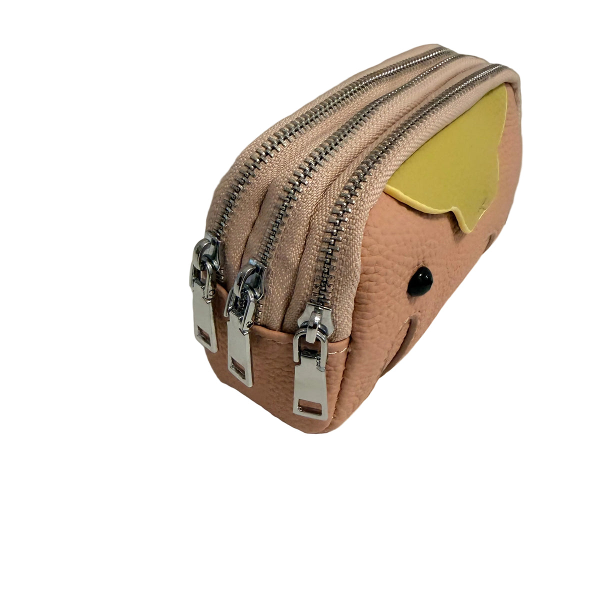 A small pebbled faux-leather pouch in a light peach-pink color, featuring three silver zippers, a yellow ear detail, and a small black eye, photographed on a white surface against a gray background.