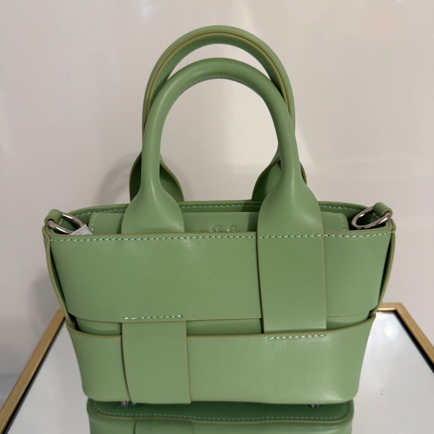 Green handbag on a white background