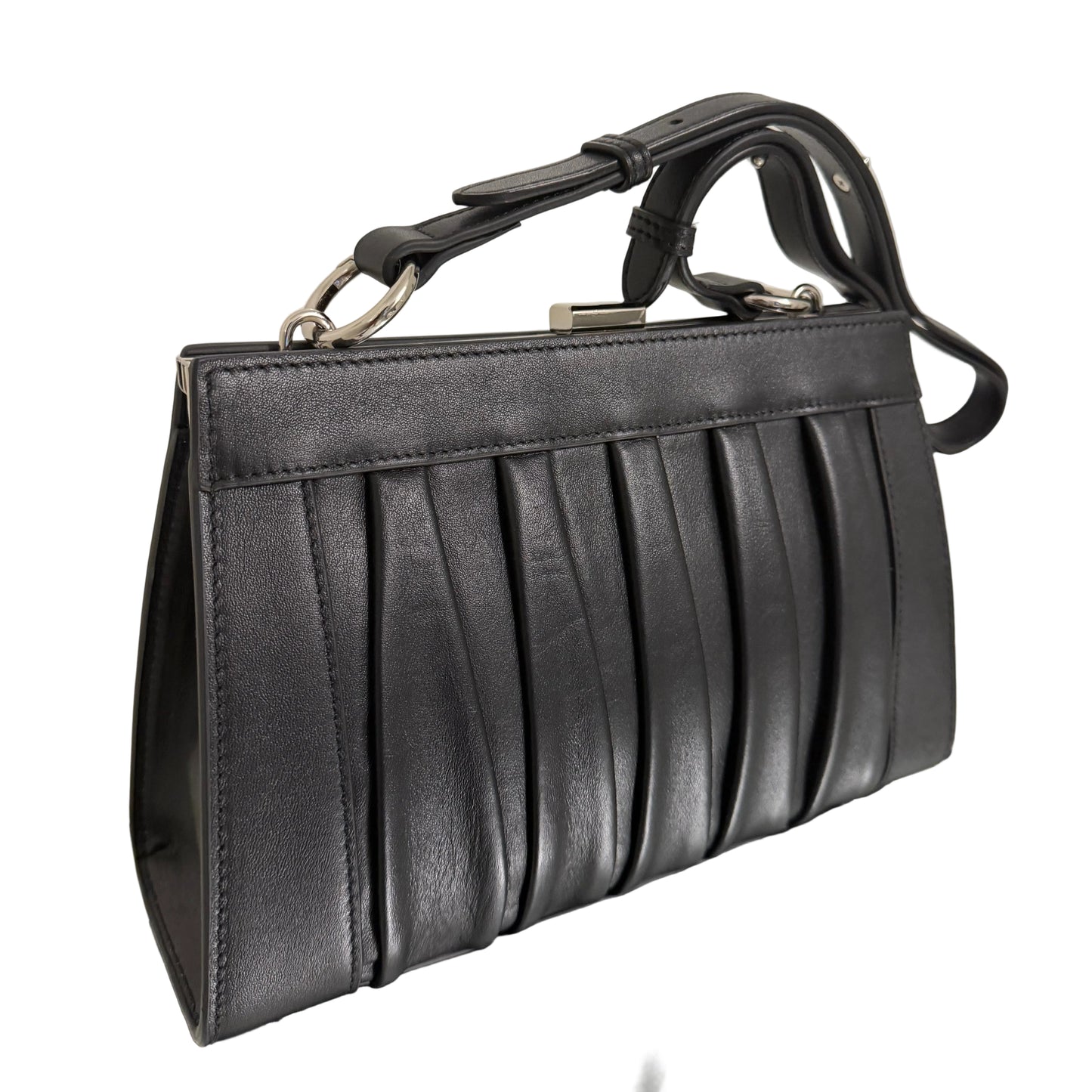 Black leather handbag on a light-colored surface