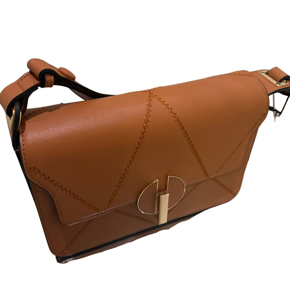 Brown leather handbag with gold accents on a reflective surface