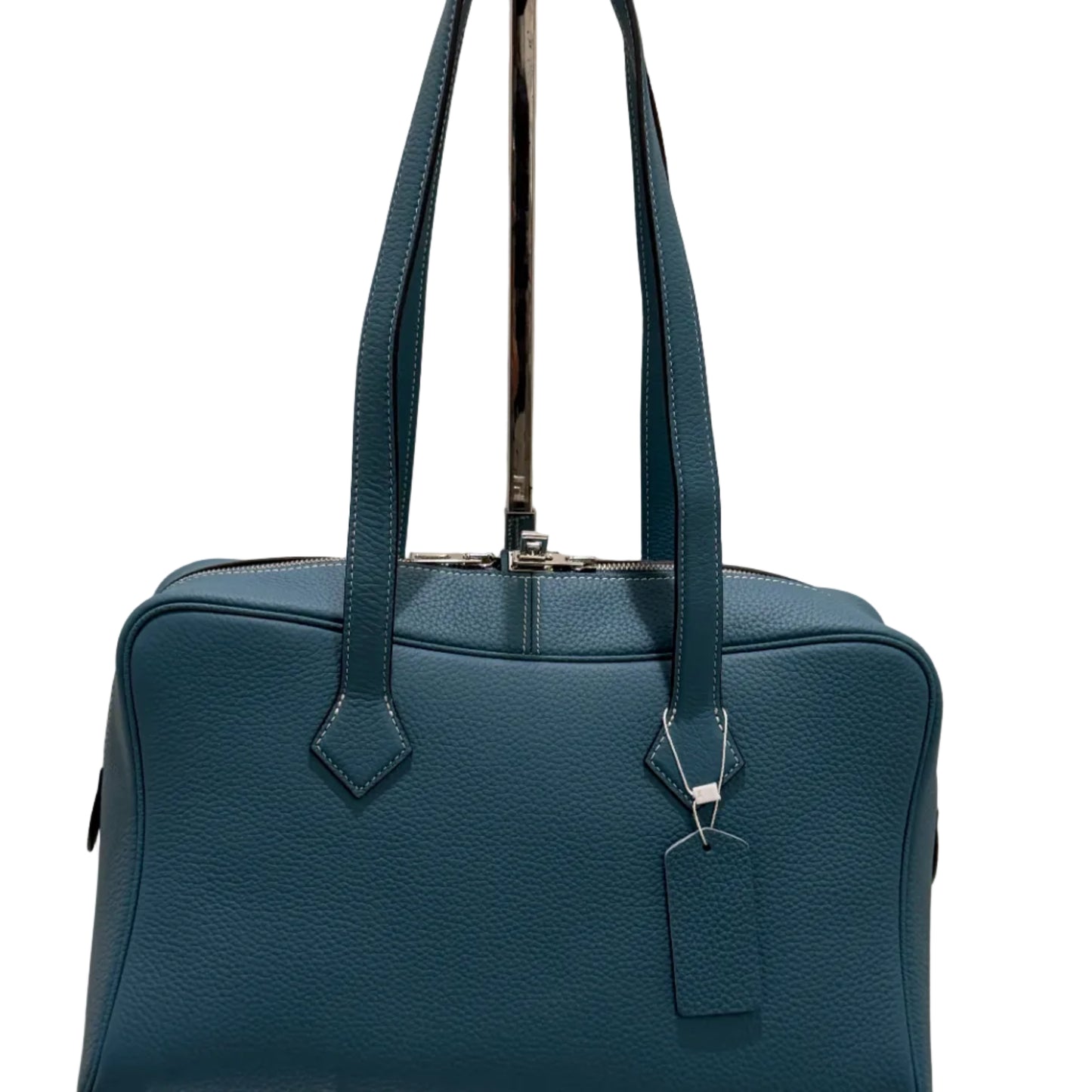 Blue handbag with a metallic clasp on a light background