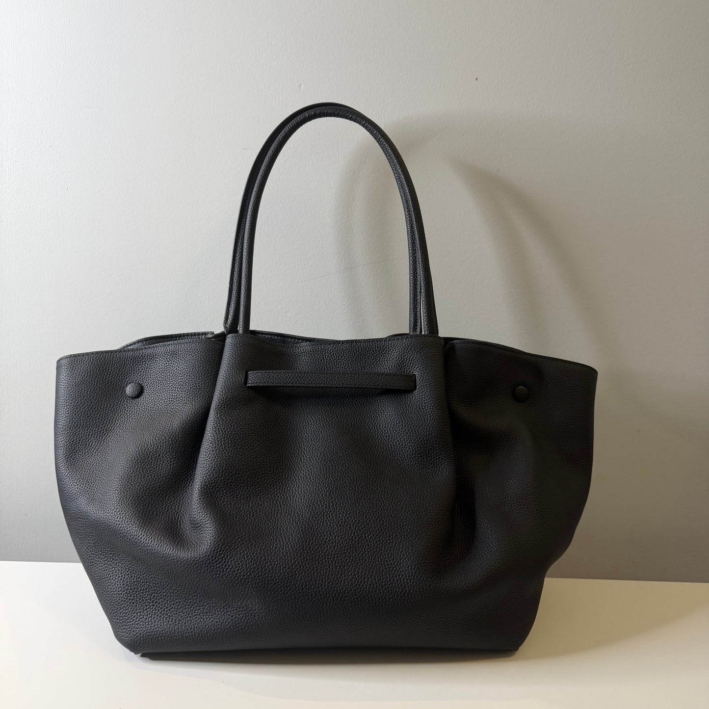 Black leather handbag on a white background