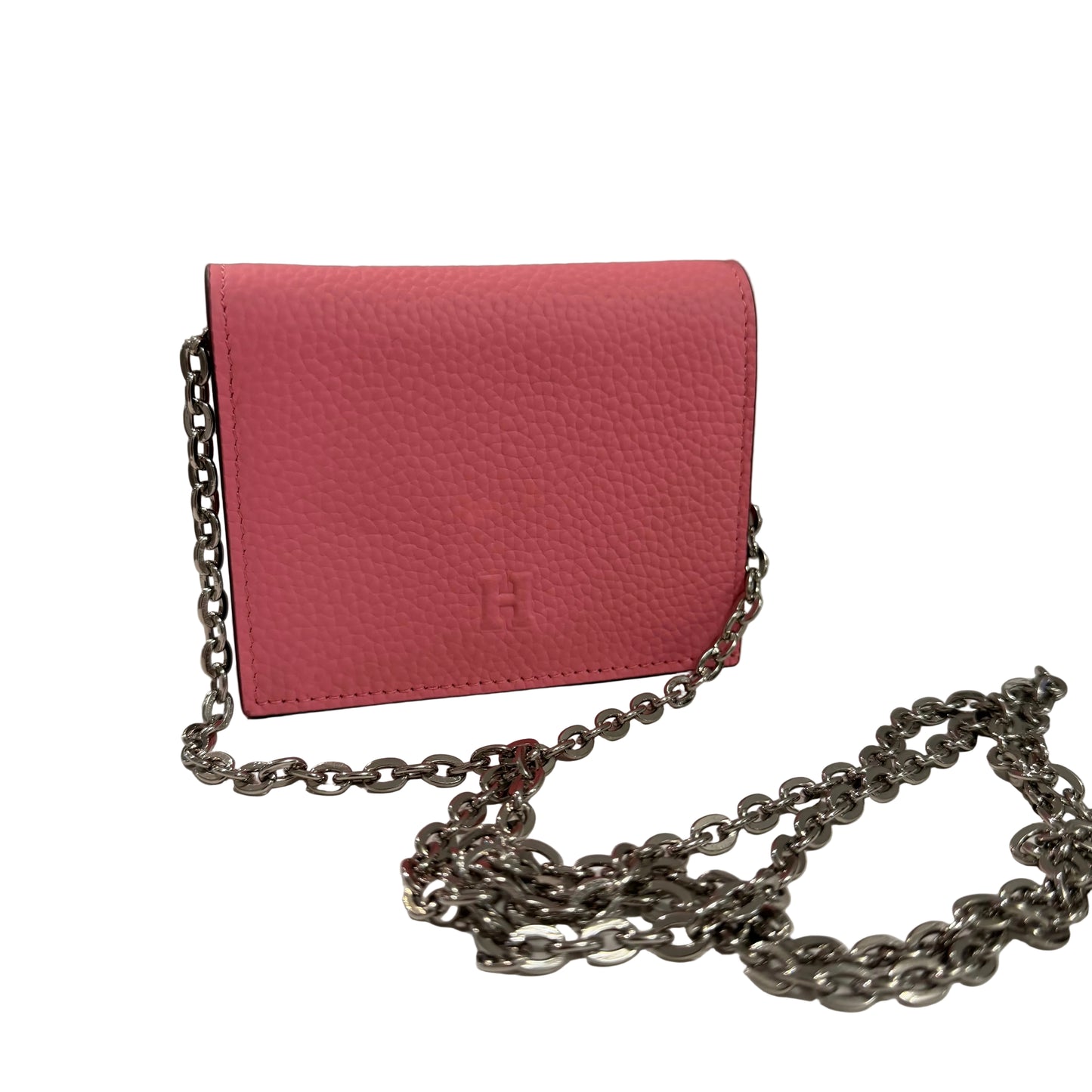 Pink wallet with a chain on a white surface and gray background