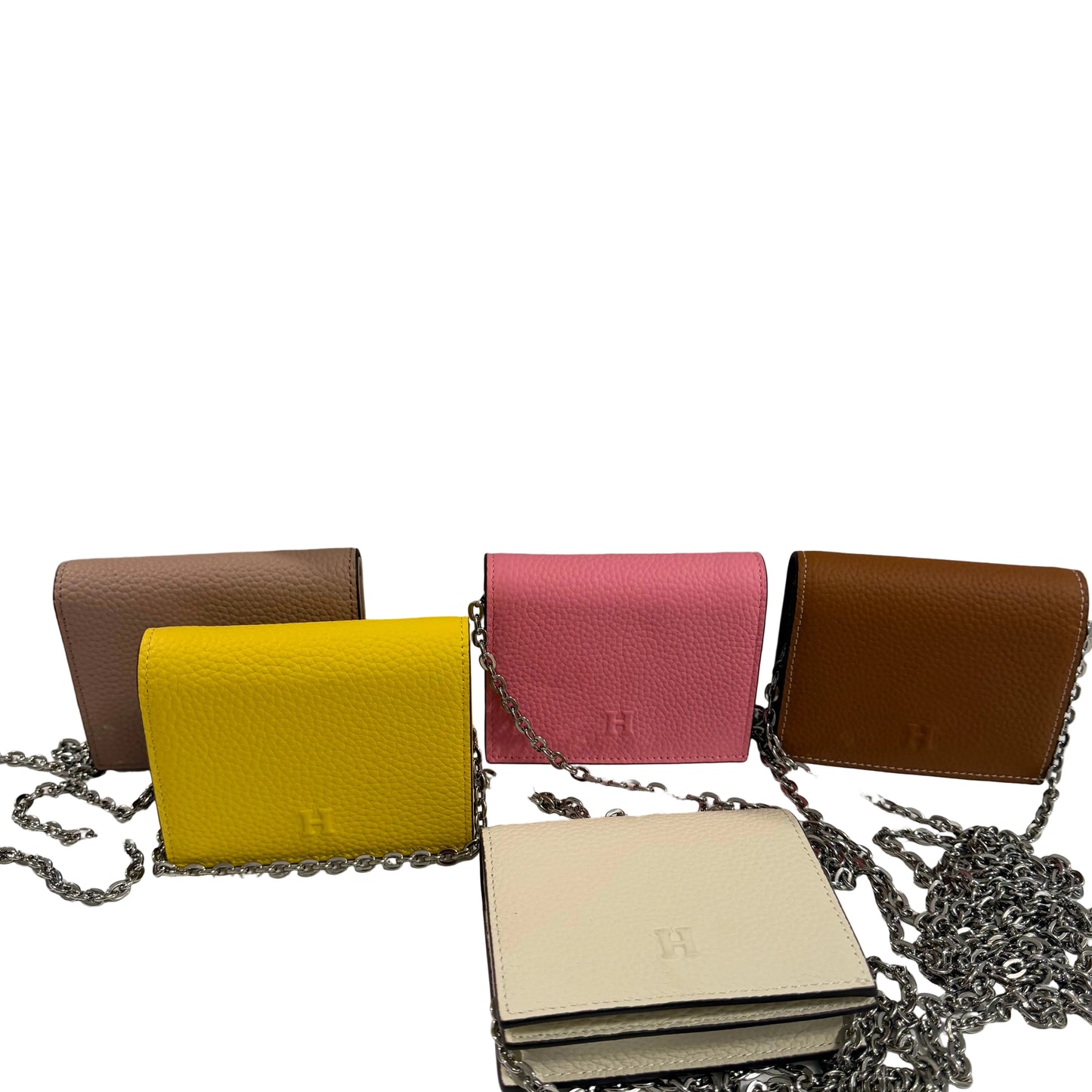 Five colorful handbags with chains on a gray background