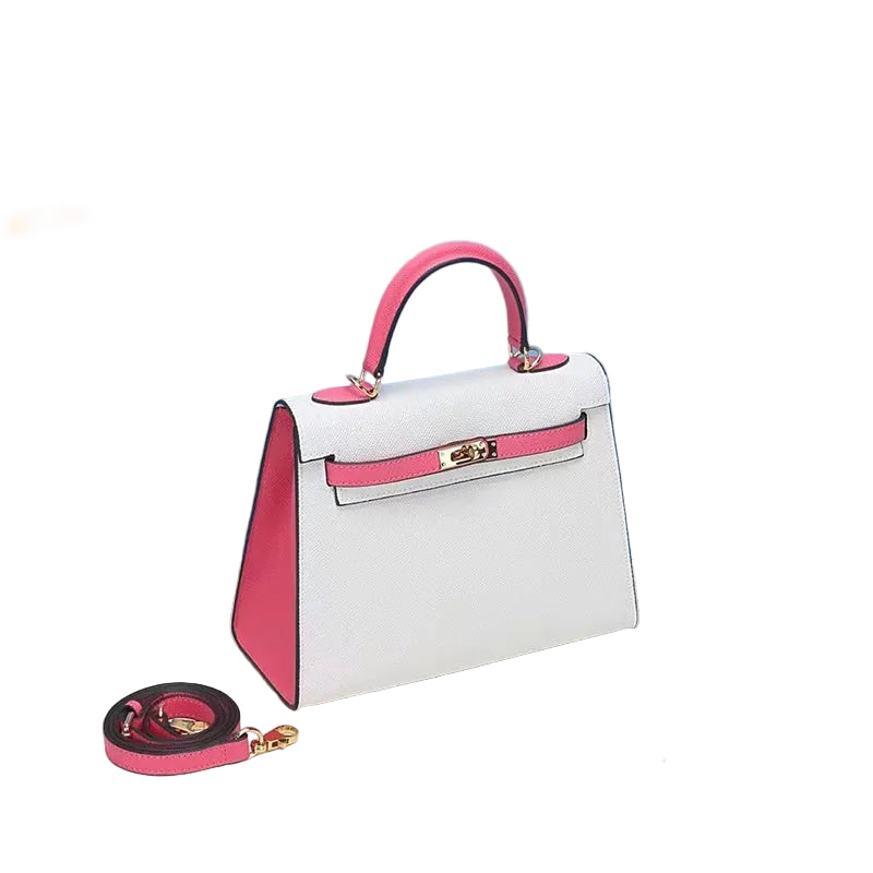 A white and pink leather handbag with a model B tag, displayed against a blue background with a small leather-look book and a lime slice to the side.
