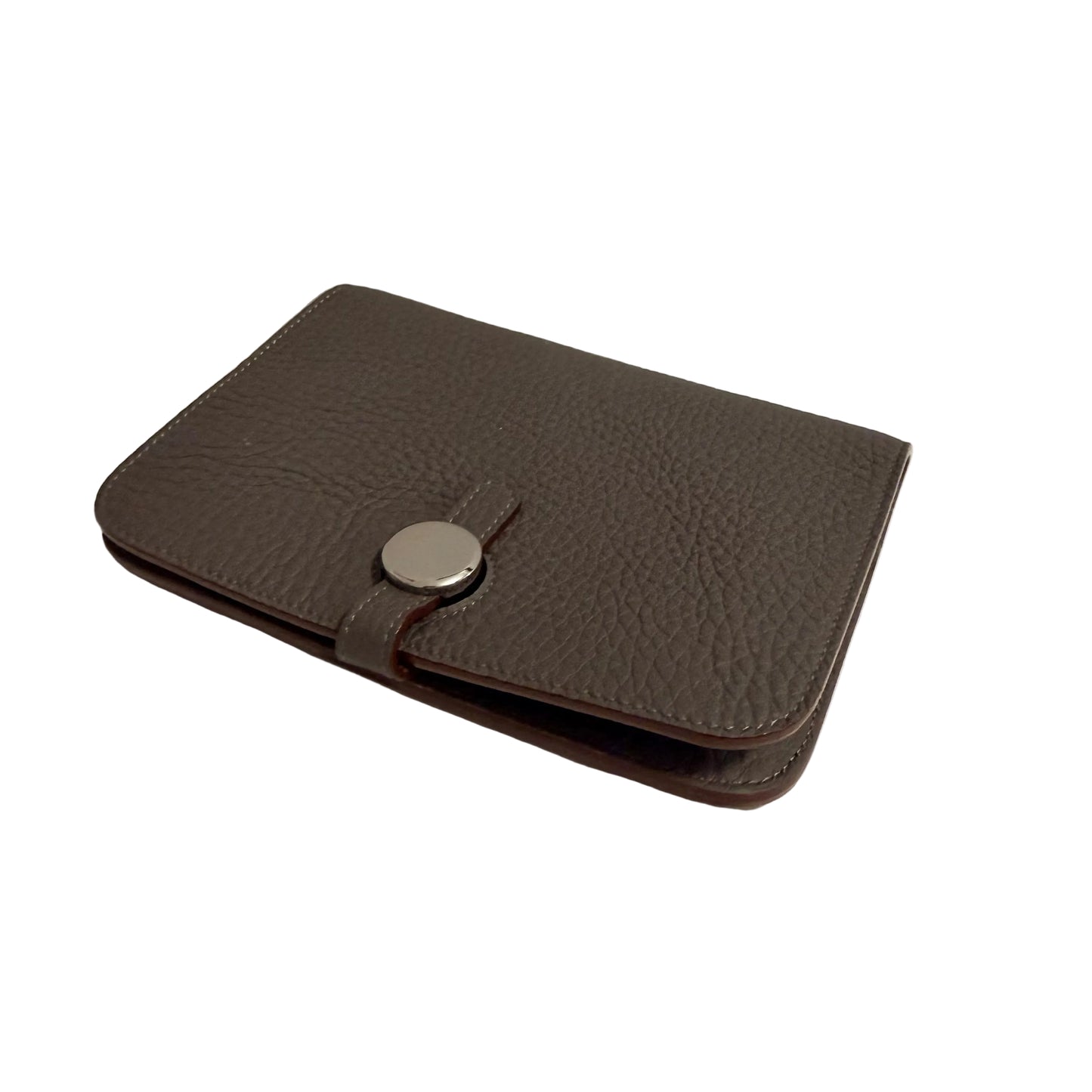 Brown leather wallet with a silver button on a white surface