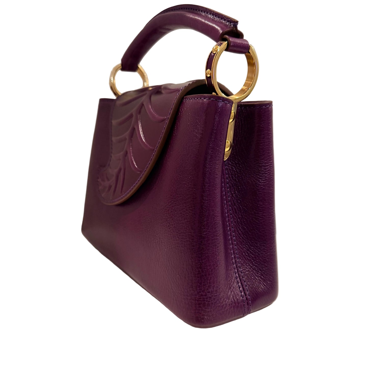 Purple handbag with gold handle on a light gray background