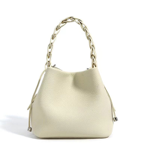 Beige handbag with chain handle on a white background