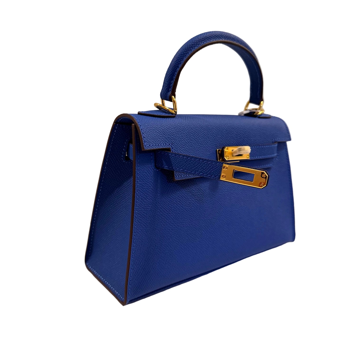 Blue handbag with gold hardware on a neutral background