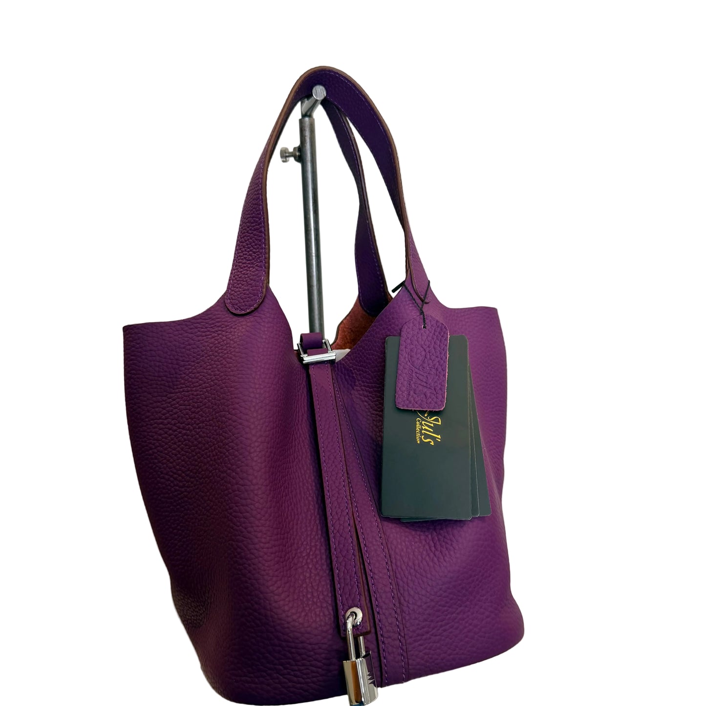 Purple handbag with a visible brand tag on a white background