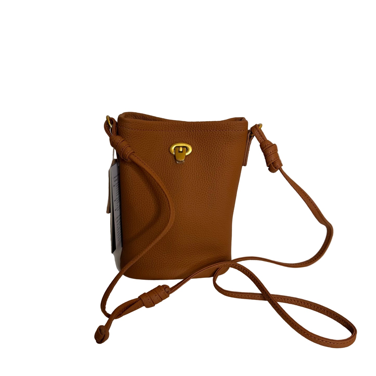 Brown leather crossbody bag with a strap on a white surface and light gray background