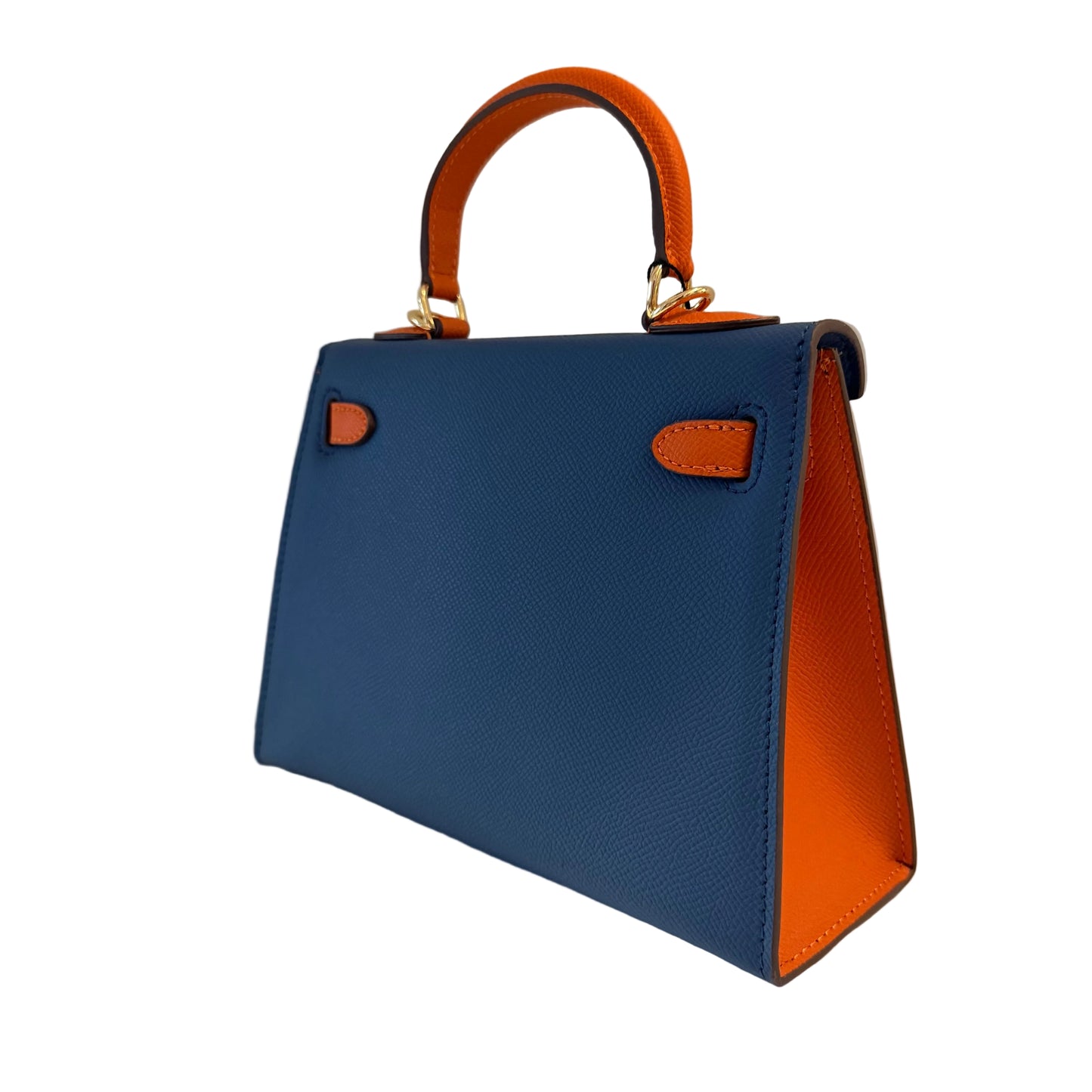 Blue handbag with orange interior and handle on a neutral background