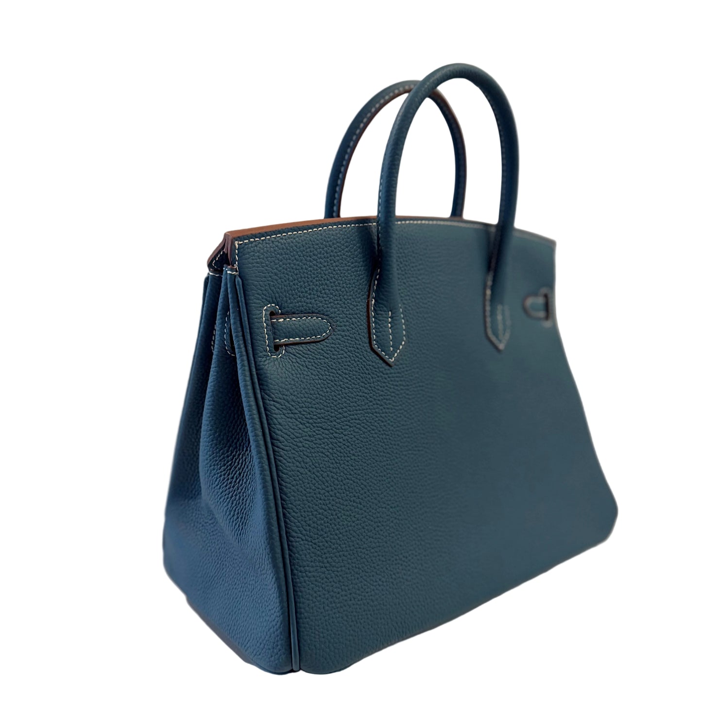 Blue leather handbag on a light gray background