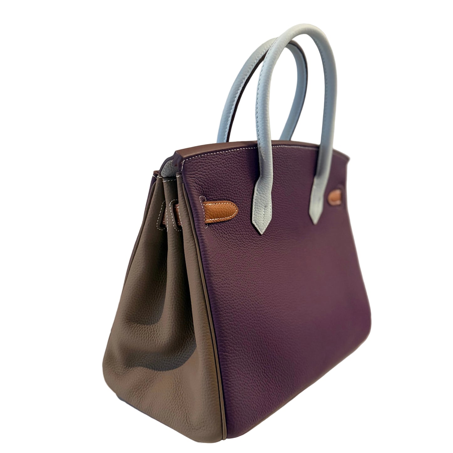 Two-tone handbag with brown and purple leather on a light gray background