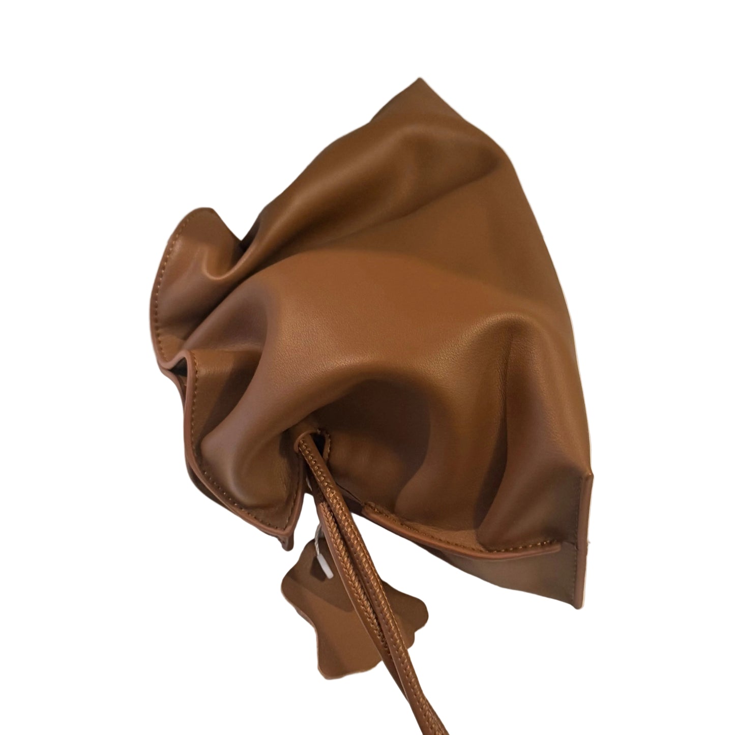 Brown leather drawstring bag on a white surface with a neutral background