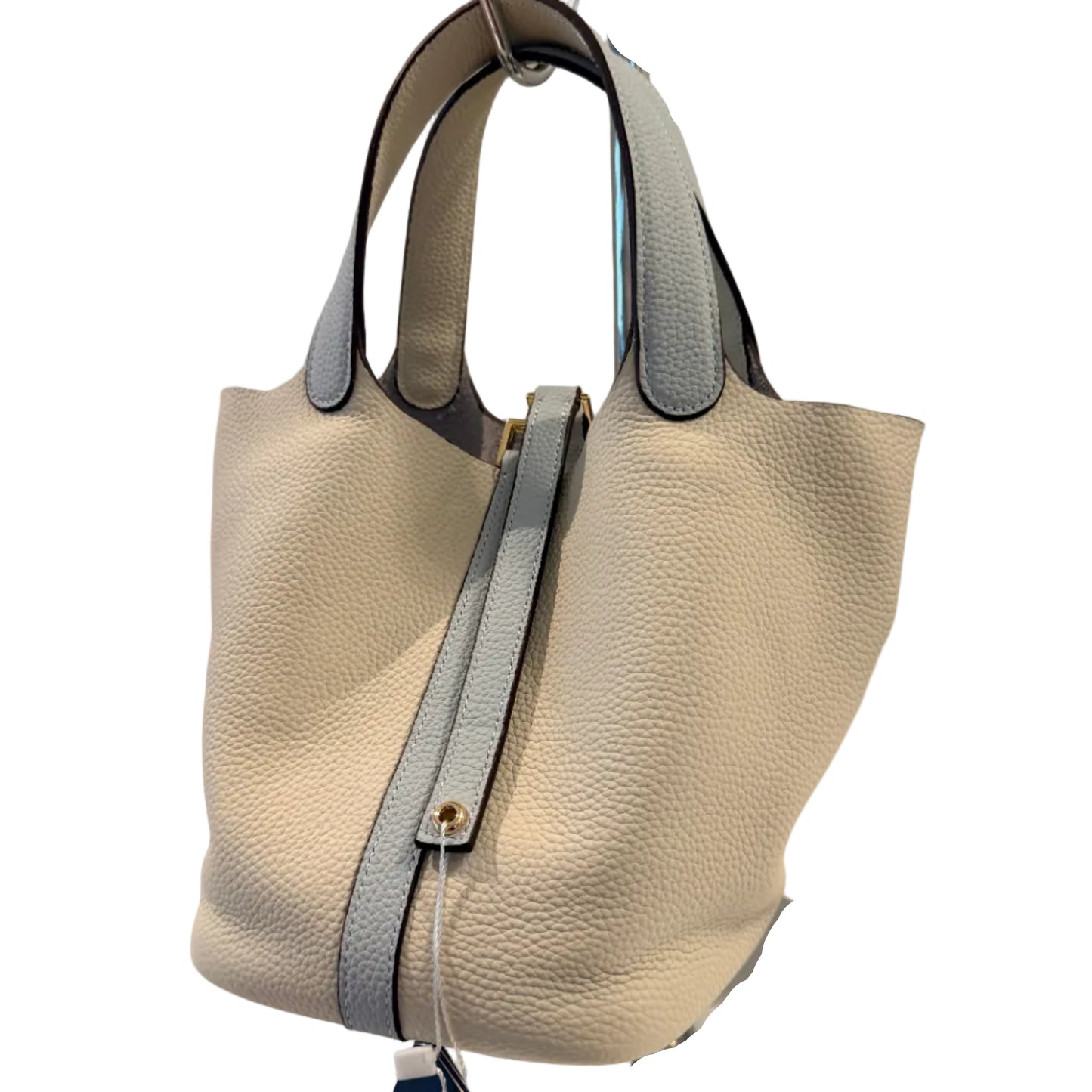 Beige leather handbag on a mannequin with a visible brand tag against a neutral background