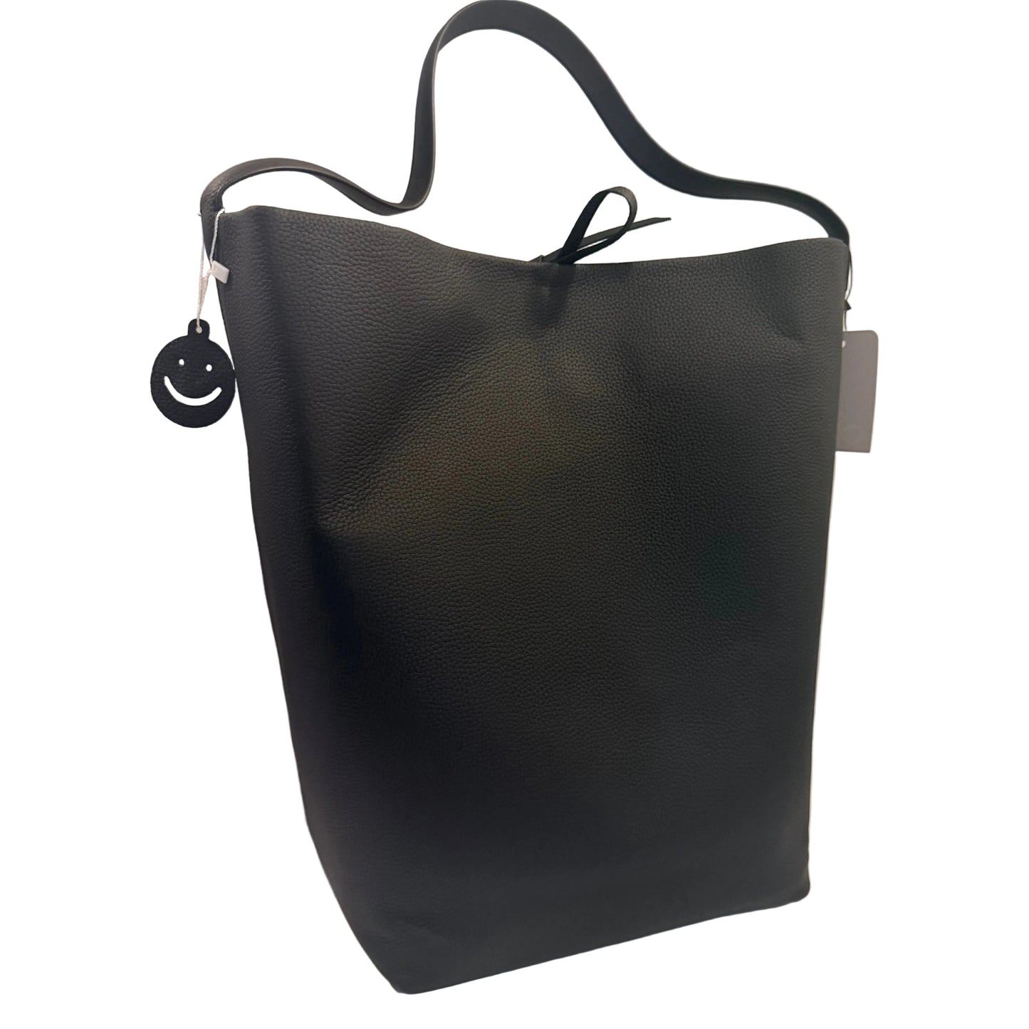 Black leather handbag on a white surface with a plain background