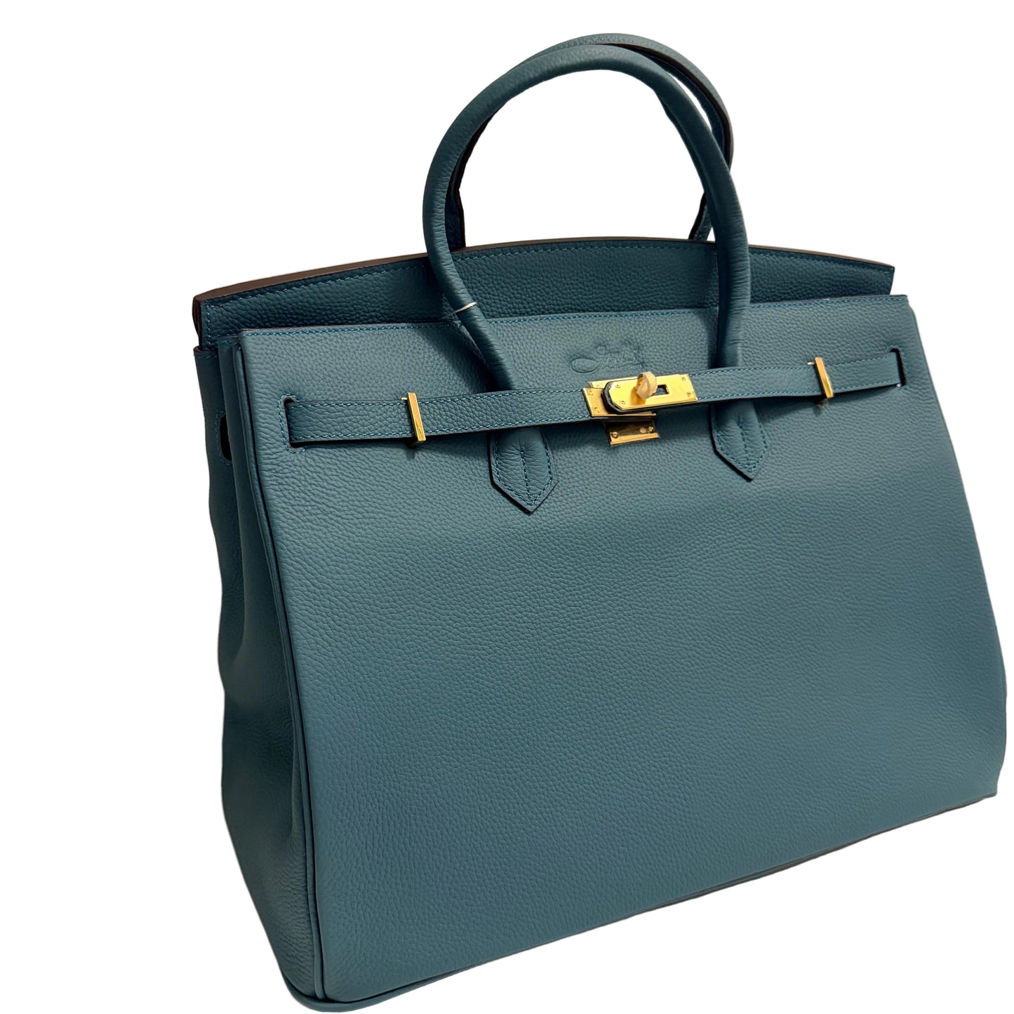 Blue handbag with gold hardware on a beige background