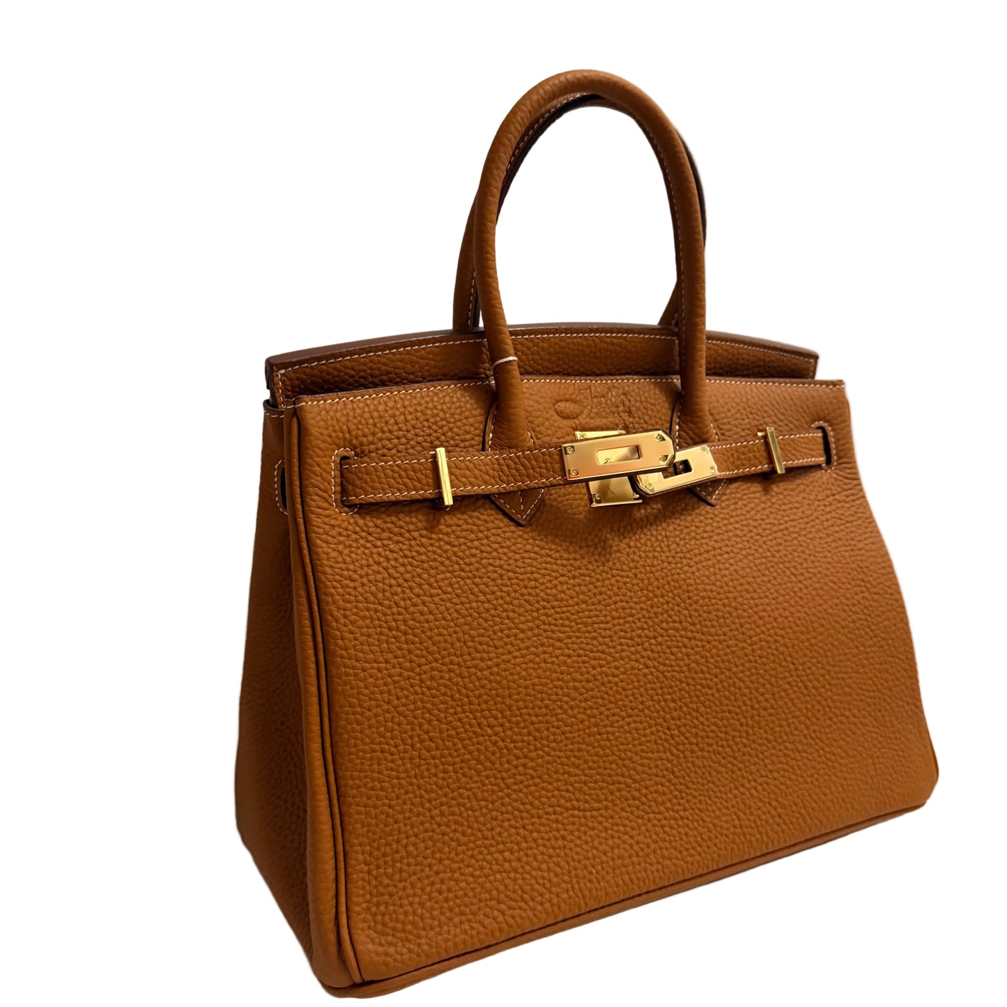 Brown leather handbag with gold hardware on a light gray background