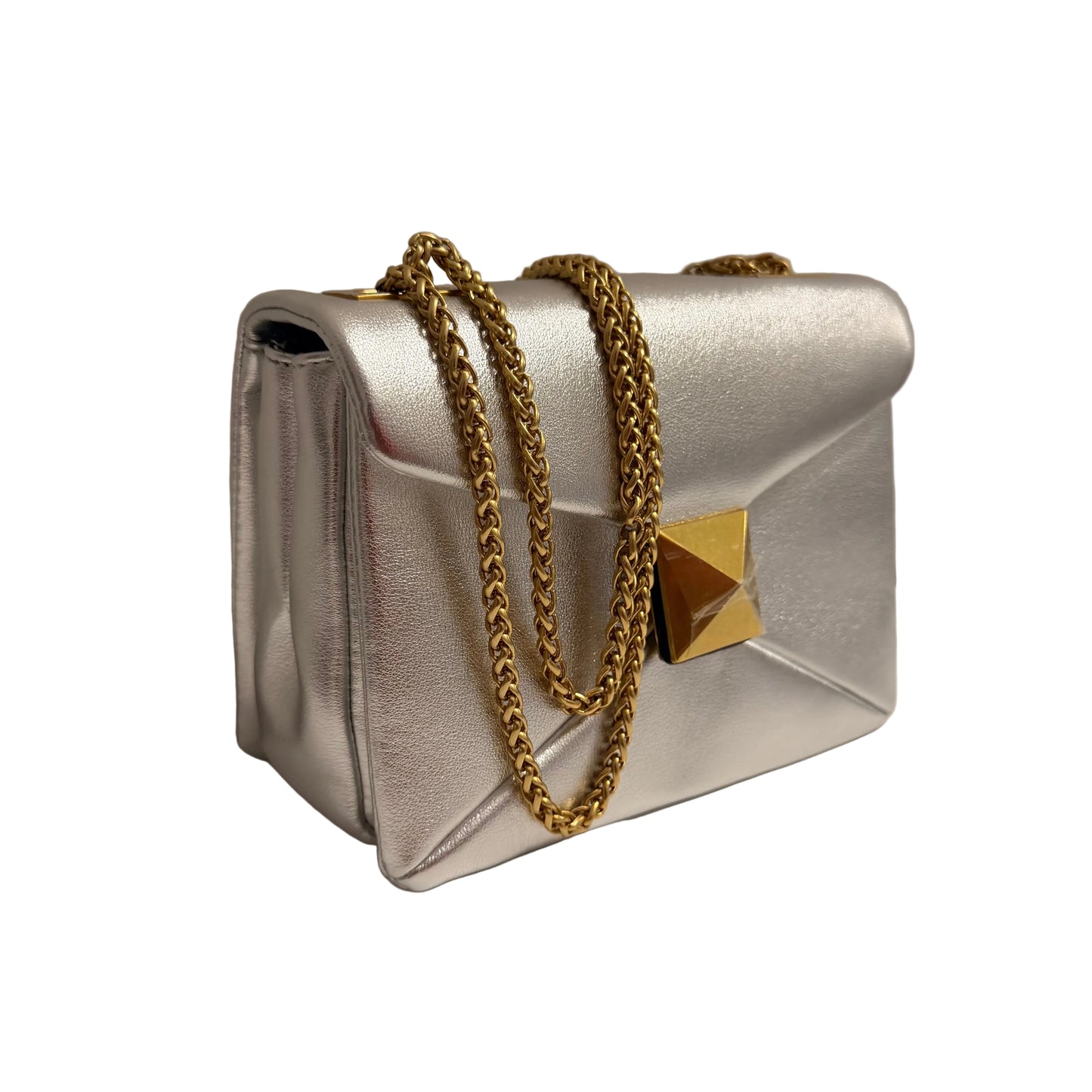 Silver handbag with a gold chain on a neutral background