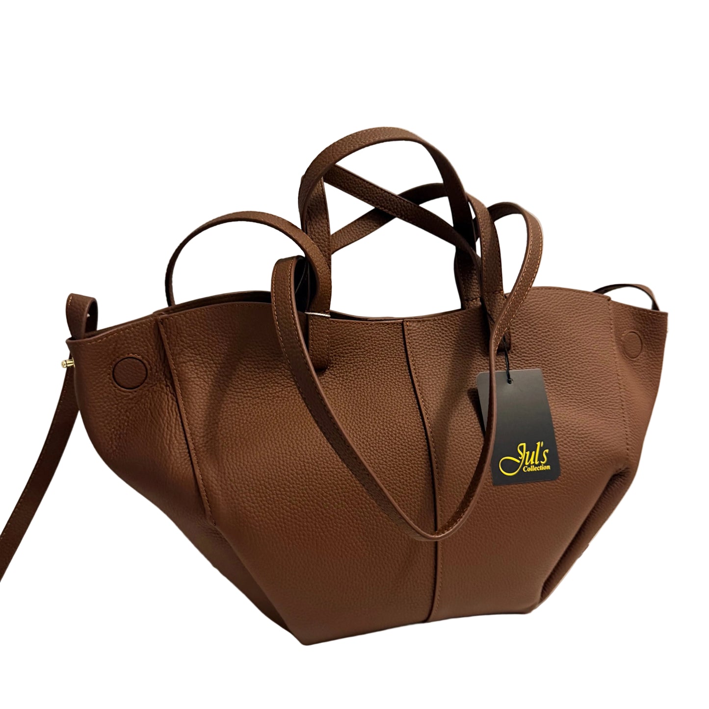 A brown pebbled faux-leather handbag with double top handles and a shoulder strap, shown on a white surface against a light gray wall. A black brand tag reading 'Jul's Style' is attached to the bag.