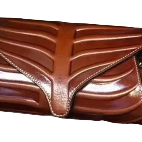 Three leaf-shaped clutches in green, brown, and red colors, displayed on a wooden surface.