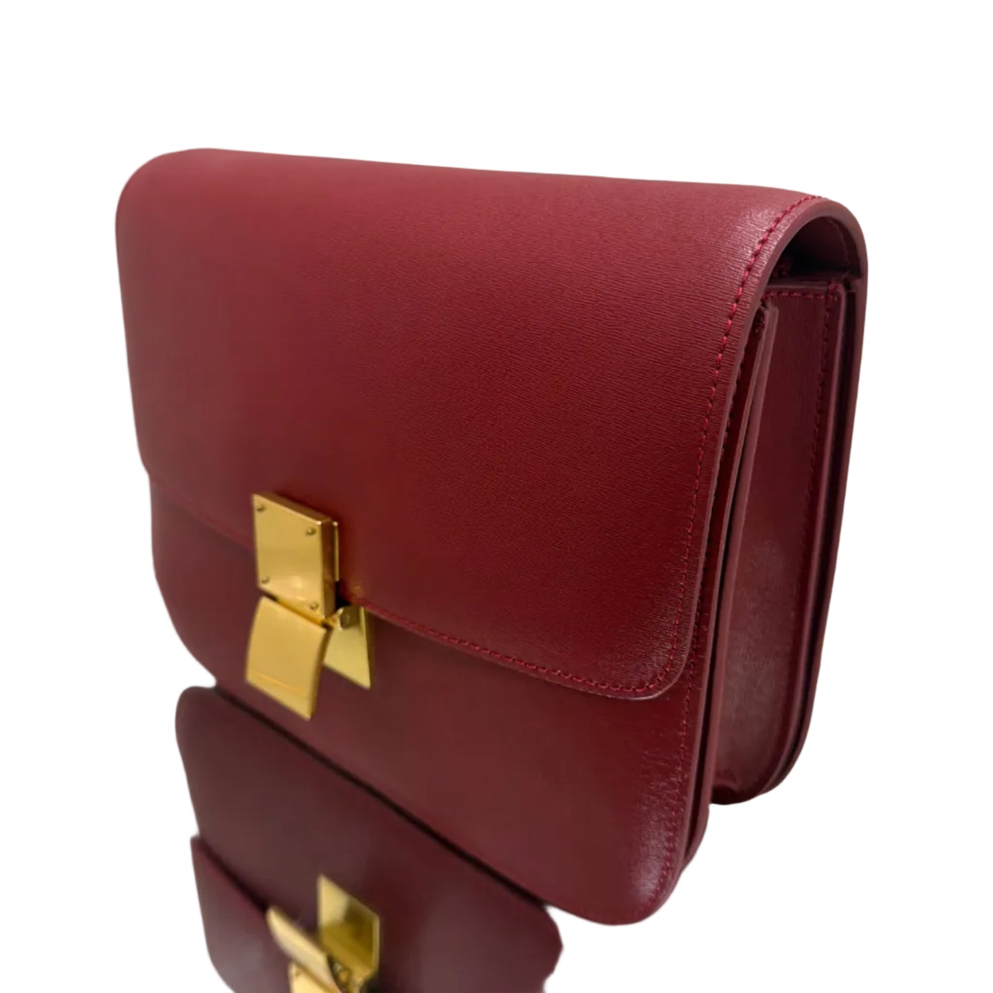 Red handbag with gold clasp on a light background