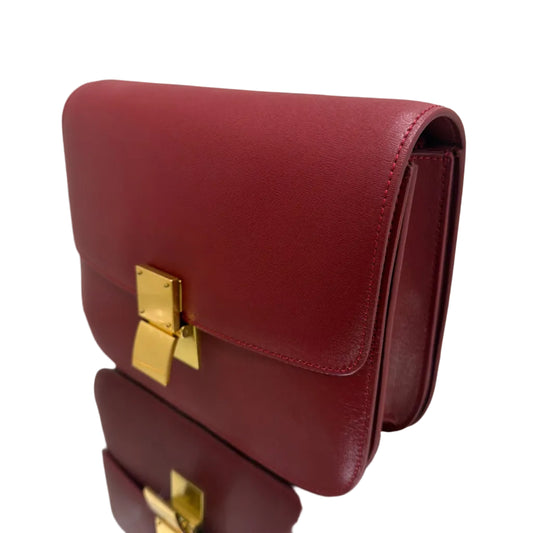 Red handbag with gold clasp on a light background